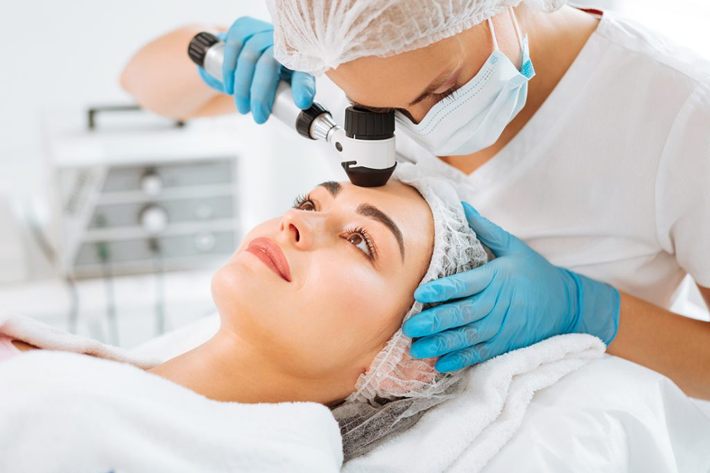 Pleasant young woman having her skin checked